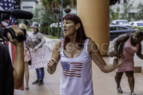 News media interviewing an angry female protester